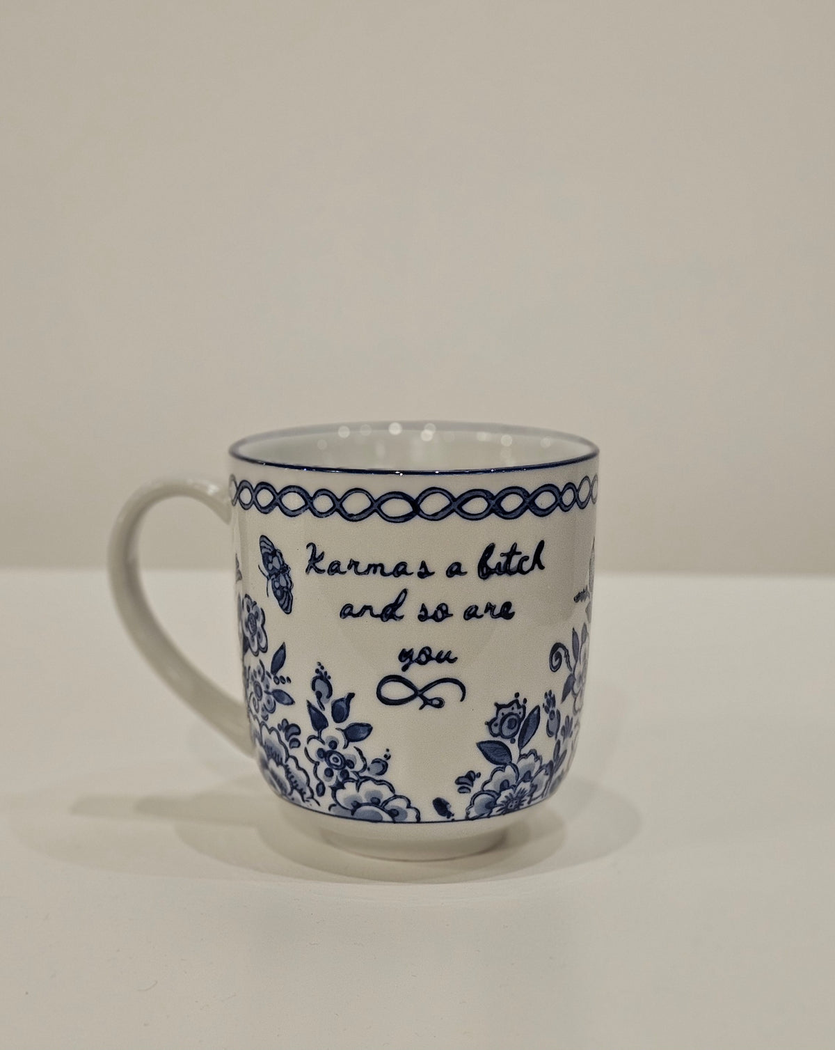 Karmas a bitch Mug